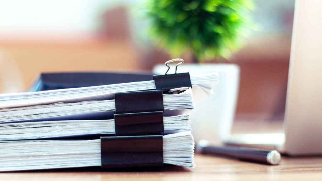 Stack Of Documents Placed On A Business Desk In A Business Office